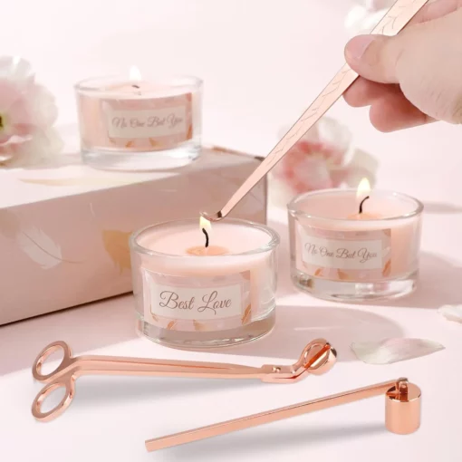 Rose gold candle accessory set with wick trimmer, dipper, and snuffer on white background