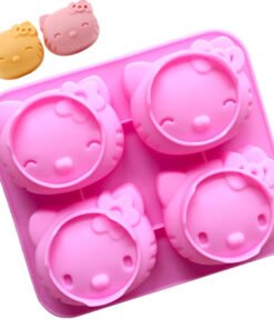 Finished cat head shaped desserts and baked bread next to the pink silicone crafting mold