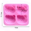 Dimensions of pink 4-cavity cartoon cat head silicone mold showing 14cm total width and 6.5cm cavity width