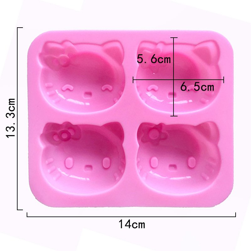 Dimensions of pink 4-cavity cartoon cat head silicone mold showing 14cm total width and 6.5cm cavity width
